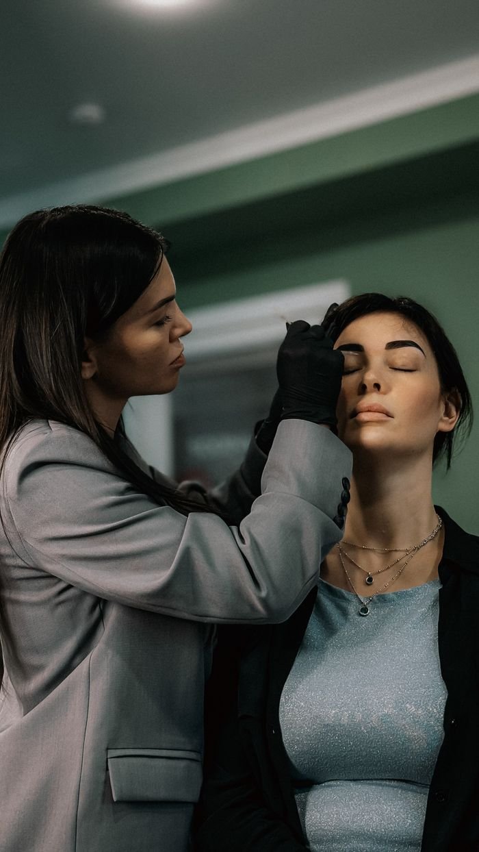 Offerings Makeup artist applying eyeshadow in a beauty salon. Indoor professional setting.